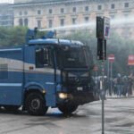 a police vehicle sprays a jet of water during a protest over the state of public services and the rising cost of living in milan