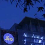 reliance industries jio telecoms logo is displayed on the jio world convention centre building on a street in mumbai