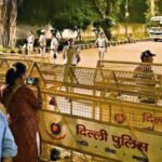 security personnel stand guard near barricades at janpath ahead of the oct 10 protest